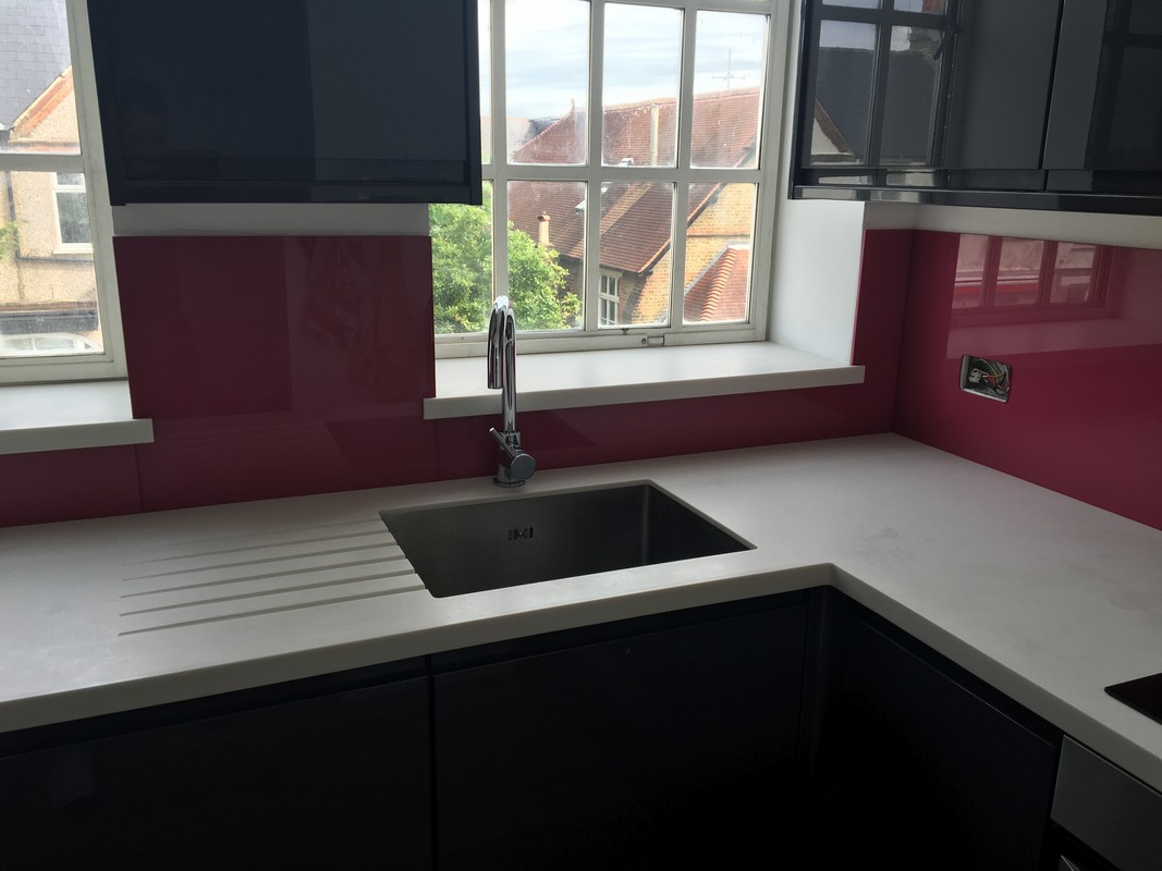 Deep plum coloured glass splashback in modern West Ealing kitchen